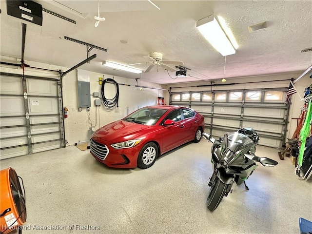 garage featuring electric panel and a garage door opener