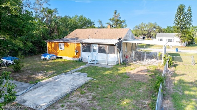 1108 Edgemoor Ave, Sebring, FL 33870 - back of property featuring a sunroom, a chimney, and entry steps