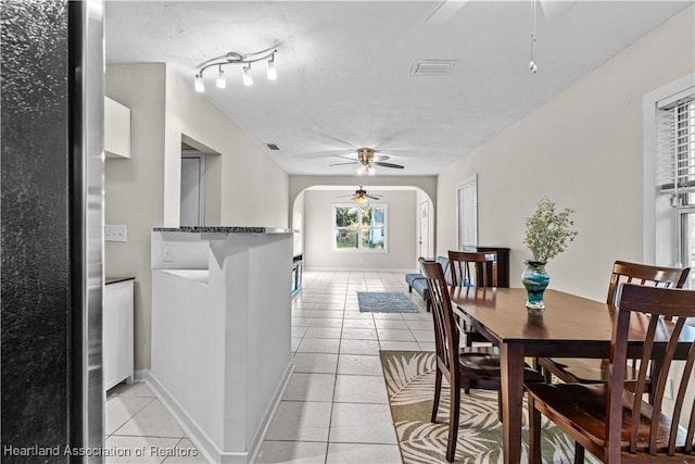 1108 Edgemoor Ave, Sebring, FL 33870 - dining area featuring ceiling fan, arched walkways, and light tile patterned floors