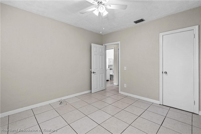 1108 Edgemoor Ave, Sebring, FL 33870 - unfurnished bedroom with light tile patterned floors, ceiling fan, and a textured ceiling