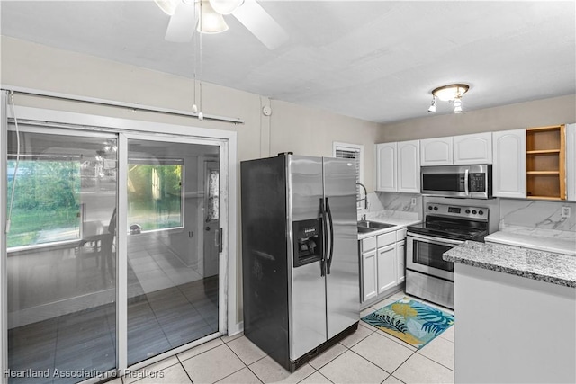 1108 Edgemoor Ave, Sebring, FL 33870 - kitchen featuring appliances with stainless steel finishes, white cabinets, ceiling fan, light tile patterned floors, and light stone countertops