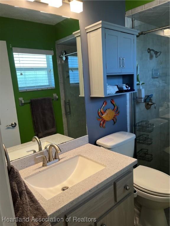 1570 Spring Ln, Lake Placid, FL 33852 - full bathroom with a shower stall, toilet, and vanity