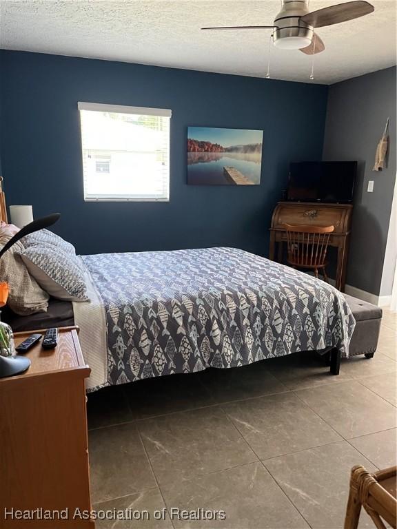 1570 Spring Ln, Lake Placid, FL 33852 - bedroom with tile patterned flooring and a ceiling fan