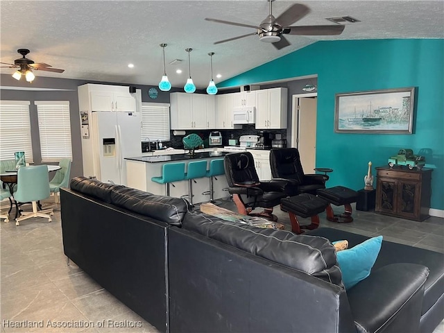 1570 Spring Ln, Lake Placid, FL 33852 - living room with a ceiling fan, a textured ceiling, vaulted ceiling, and recessed lighting