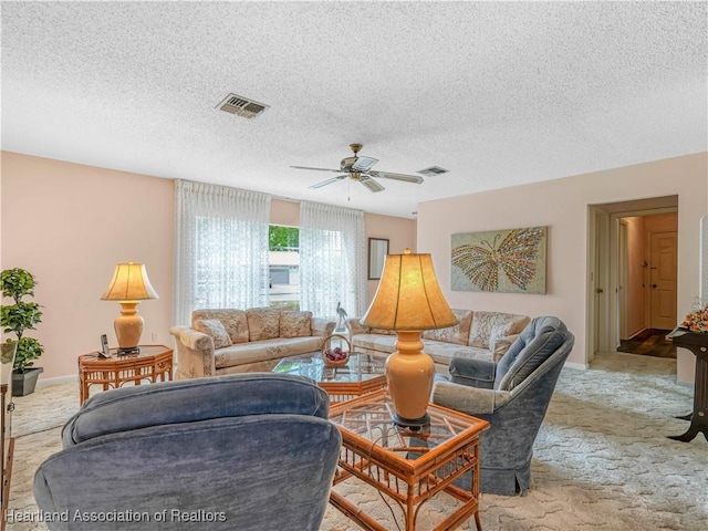 living room featuring light carpet, visible vents, and a ceiling fan