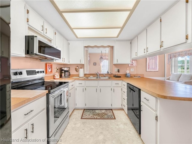 kitchen with appliances with stainless steel finishes, white cabinets, and light countertops