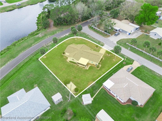 birds eye view of property with a water view