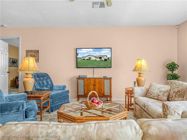 living area featuring visible vents and a textured ceiling