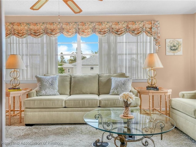 living room with a ceiling fan and a wealth of natural light