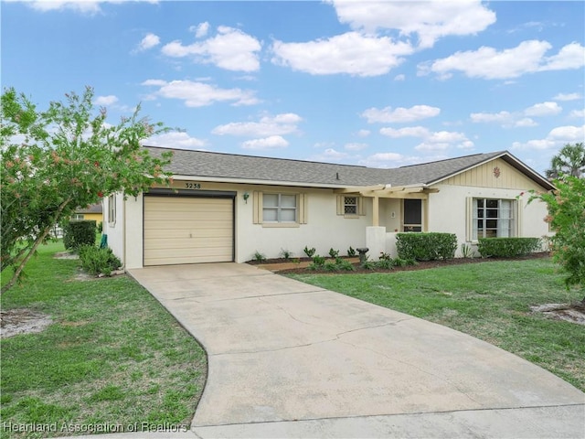 ranch-style home with a garage, roof with shingles, concrete driveway, and a front yard