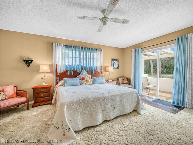 carpeted bedroom with baseboards, access to outside, a ceiling fan, and a textured ceiling