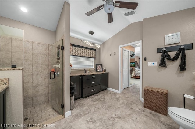 bathroom with vaulted ceiling, vanity, ceiling fan, toilet, and a shower with door