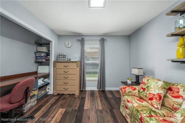 sitting room with dark wood-type flooring