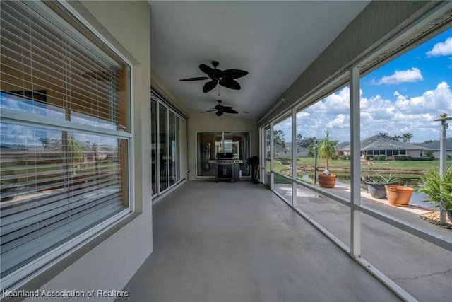 unfurnished sunroom with vaulted ceiling and ceiling fan