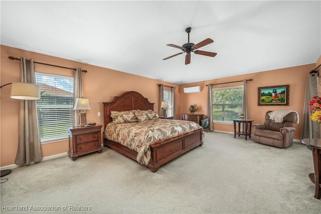 bedroom with multiple windows, carpet, a wall unit AC, and ceiling fan