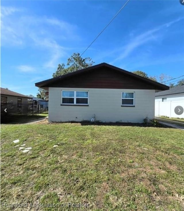 view of side of home with a lawn