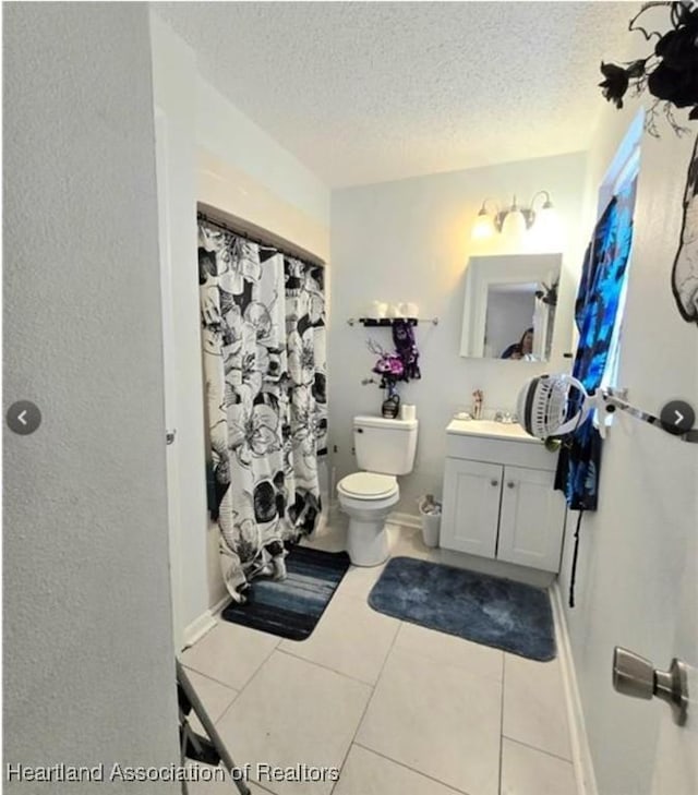 full bathroom featuring shower / bath combo, tile patterned flooring, vanity, a textured ceiling, and toilet