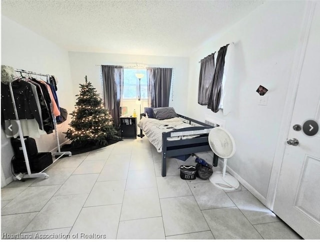 bedroom with light tile patterned floors and a textured ceiling