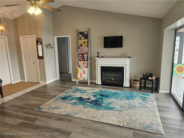 living room featuring vaulted ceiling, ceiling fan, and hardwood / wood-style floors