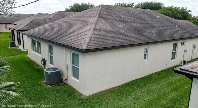 view of home's exterior featuring a yard and central AC