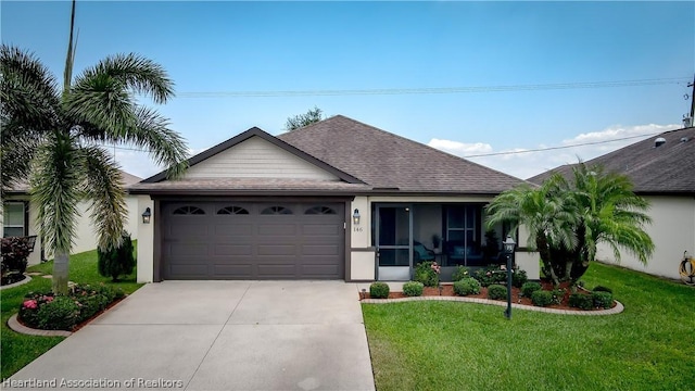 view of front of house featuring a front yard and a garage