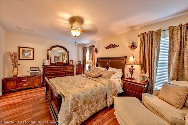 bedroom with ceiling fan and light hardwood / wood-style flooring