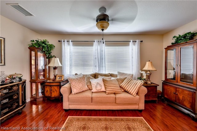 living room featuring dark hardwood / wood-style floors and ceiling fan