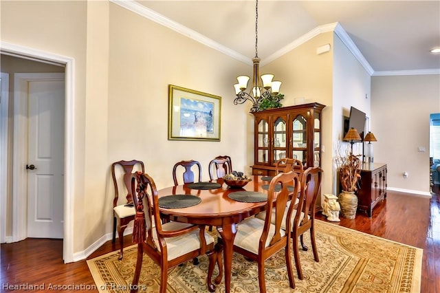 dining space with a notable chandelier, dark hardwood / wood-style floors, ornamental molding, and lofted ceiling