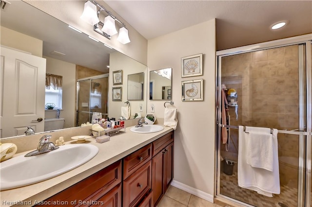 bathroom with tile patterned floors, vanity, and walk in shower