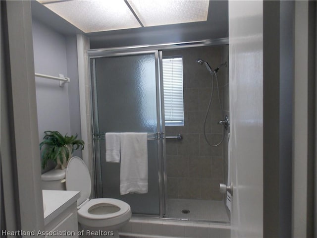 bathroom with vanity, toilet, and walk in shower