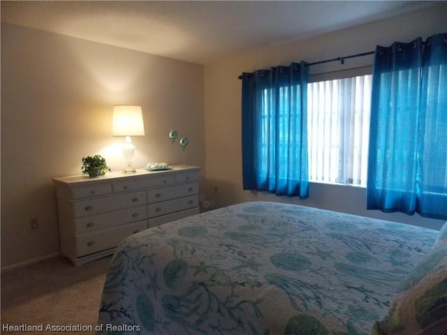 bedroom featuring light carpet