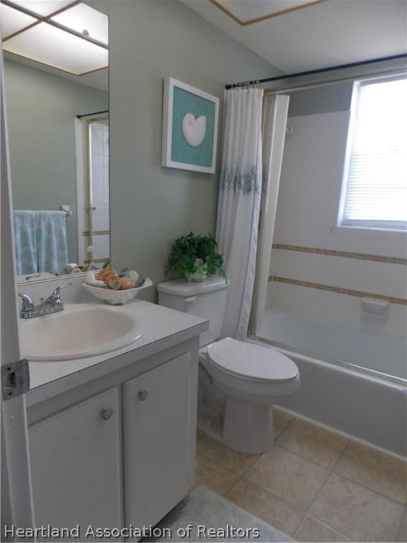 full bathroom featuring tile patterned flooring, vanity, shower / bath combo, and toilet