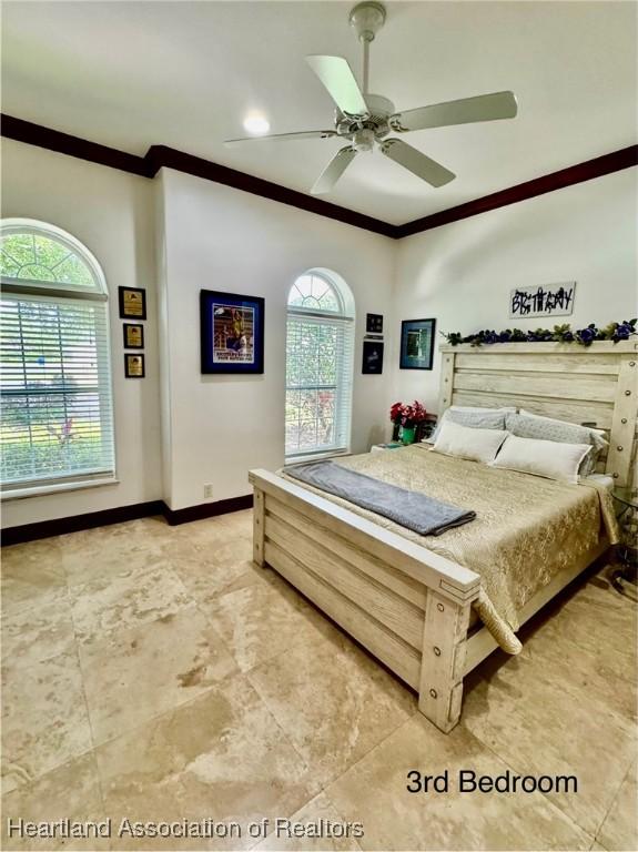 4205 Cremona Ct, Sebring, FL 33872 - bedroom with crown molding, baseboards, and a ceiling fan