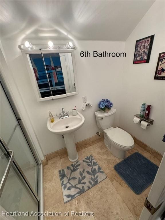 4205 Cremona Ct, Sebring, FL 33872 - bathroom featuring a shower stall, tile patterned flooring, toilet, lofted ceiling, and baseboards