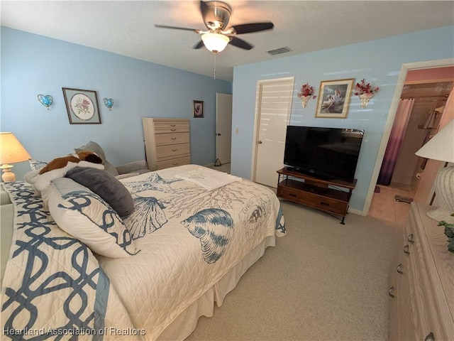 carpeted bedroom with ceiling fan