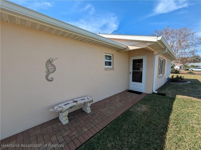 property entrance with a yard