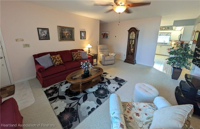 living room featuring sink, ceiling fan, and light tile patterned flooring