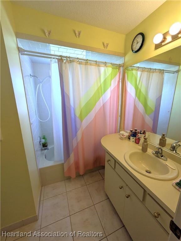 bathroom featuring shower / tub combo, vanity, tile patterned floors, and a textured ceiling