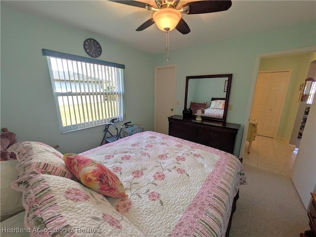 tiled bedroom featuring ceiling fan