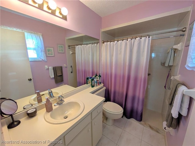 bathroom with vanity, toilet, tile patterned floors, a textured ceiling, and a shower with curtain