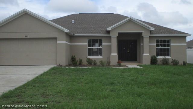 single story home featuring a front yard and a garage