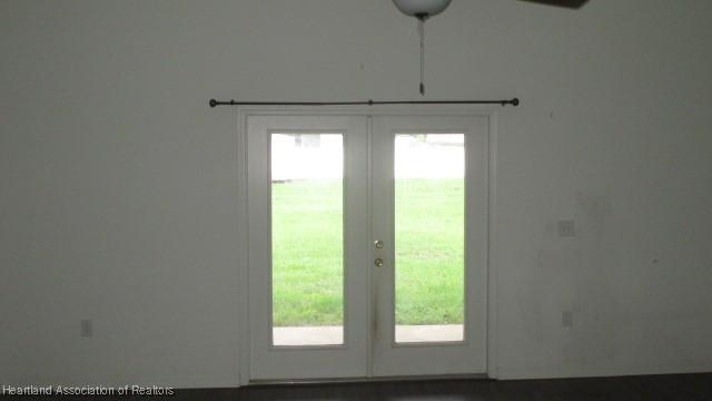 doorway to outside with french doors and a healthy amount of sunlight