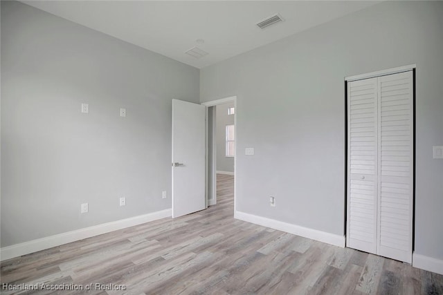 2545 N Odessa Rd, Avon Park, FL 33825 - unfurnished bedroom featuring wood finished floors, baseboards, and a closet