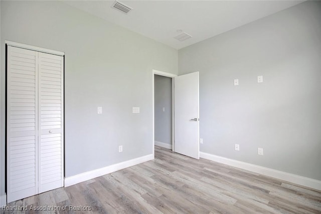 2545 N Odessa Rd, Avon Park, FL 33825 - unfurnished bedroom featuring wood finished floors, baseboards, and a closet