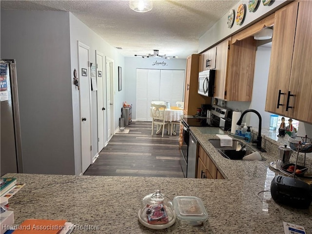 103 Fox Rd, Lake Placid, FL 33852 - kitchen with a sink, dark wood-style flooring, a textured ceiling, and appliances with stainless steel finishes