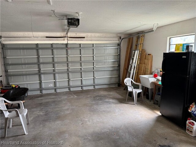 103 Fox Rd, Lake Placid, FL 33852 - garage featuring freestanding refrigerator and a garage door opener