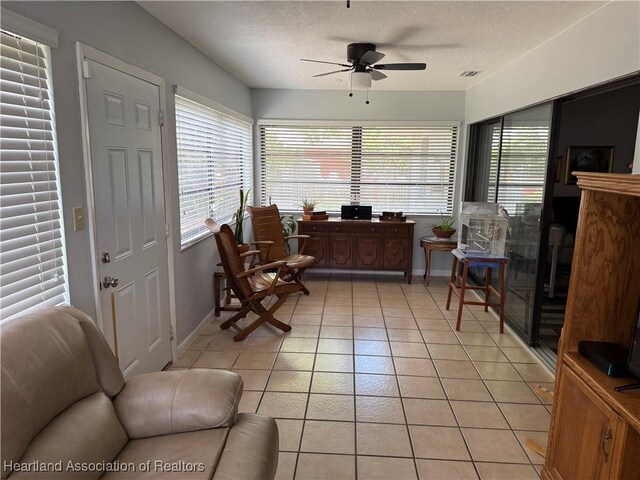 103 Fox Rd, Lake Placid, FL 33852 - living area with light tile patterned floors, a ceiling fan, a textured ceiling, visible vents, and baseboards