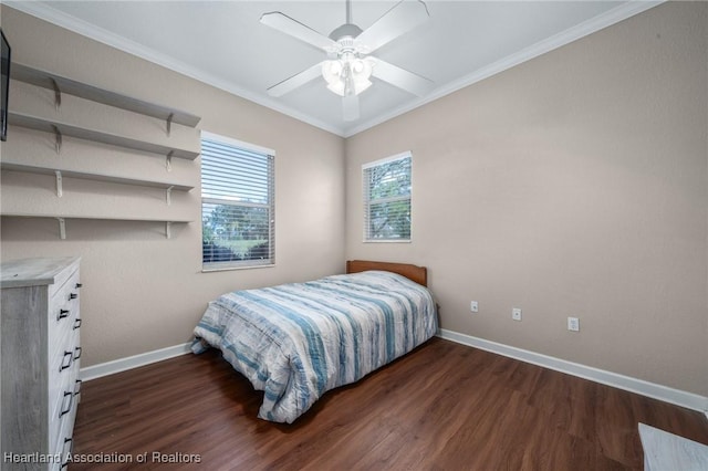 bedroom with dark hardwood / wood-style flooring, ceiling fan, and crown molding