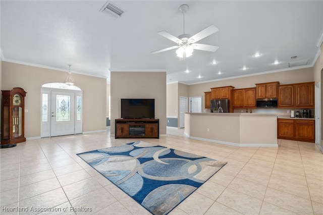 living room featuring ceiling fan, ornamental molding, and light tile patterned floors