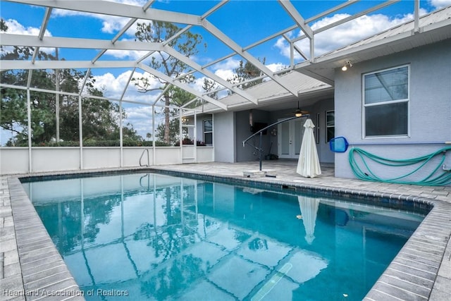 view of swimming pool with a patio area and a lanai